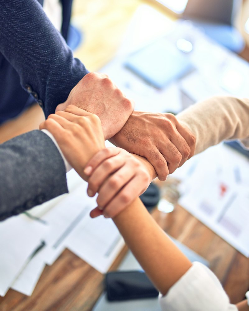 Team members joining hands