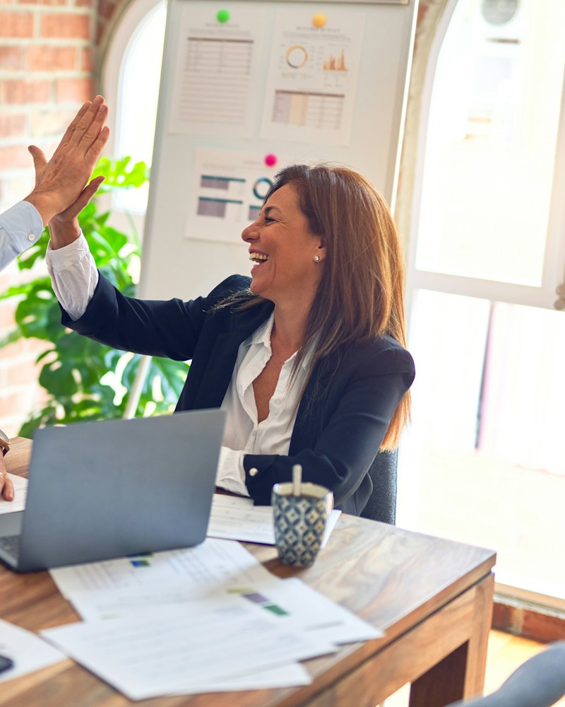 Colleagues celebrating a win with a high five